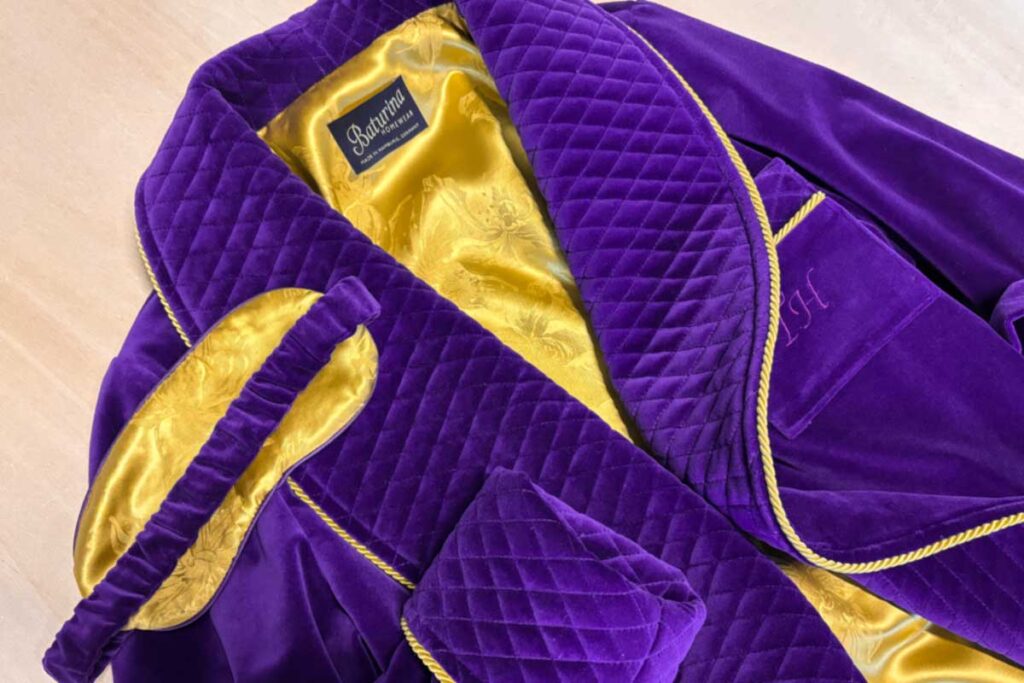 Men's purple velvet smoking jacket with gold silk lining and quilted shawl collar